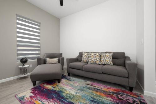 a living room with a couch and a chair at Quinta Real 5125 in McAllen