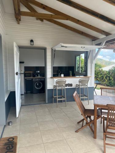 a kitchen with a table and chairs on a patio at Kaz Karaîb' in Fond Belle Fontaine