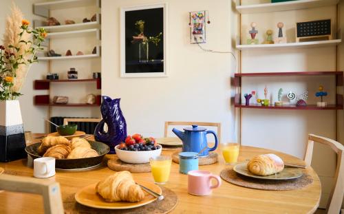 a table with croissants and a plate of food on it at Modja Modja House in Kent