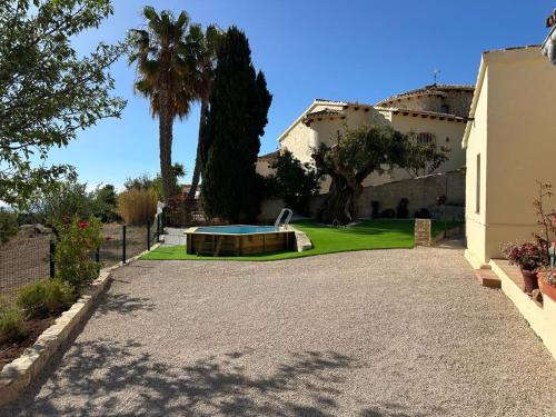 a villa with a swimming pool in a yard at Chalet Cucarres in Calpe