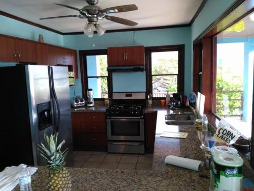 a kitchen with a refrigerator and a stove top oven at Costa Rica Beach Sanctuary in Bajamar