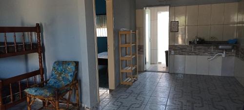 a room with a staircase and a chair in a room at Kitnet Região Central in Itapoa