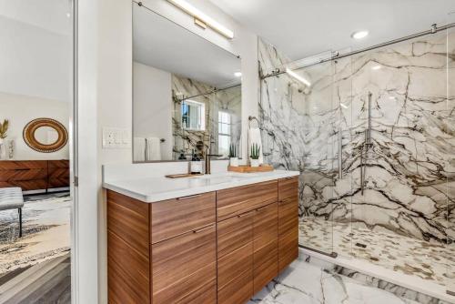 a bathroom with a sink and a shower at Aurora 6 BR Elevator Theater Rec Room Pool & Hot in Corolla
