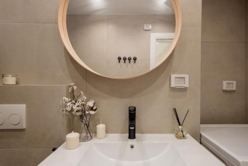 a bathroom with a white sink and a mirror at family apartment in Jerusalem