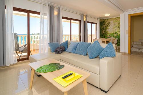 a living room with a white couch and a table at Front Line Apartment Jakarta 2 in El Campello