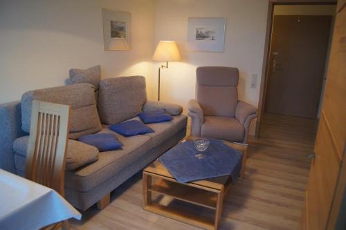 a living room with a couch and a chair at Ferienwohnung Auszeit 511 in Bad Rodach