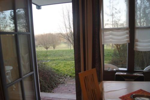an open door to a patio with a view of a yard at Ferienwohnung Auszeit 511 in Bad Rodach