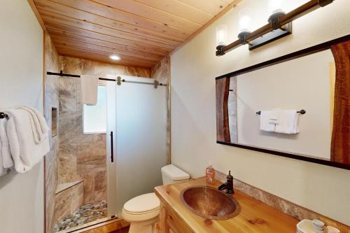 a bathroom with a sink and a mirror at River Rock Lodge in South Lake Tahoe