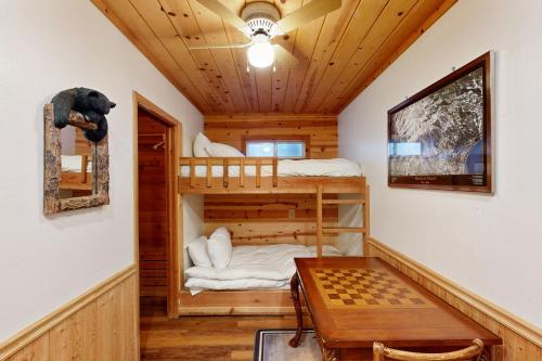 a room with two bunk beds and a table at River Rock Lodge in South Lake Tahoe