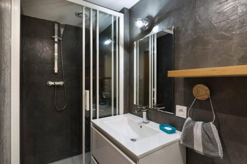 een badkamer met een witte wastafel en een douche bij Une escale de charme au port de Dinan ... in Dinan