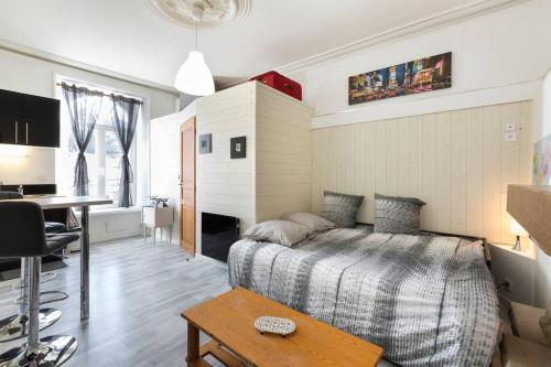 een slaapkamer met een bed en een bureau in een kamer bij Une escale de charme au port de Dinan ... in Dinan