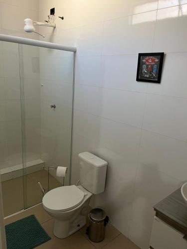 a white bathroom with a toilet and a sink at St. Benoit suites e hostel in Presidente Prudente