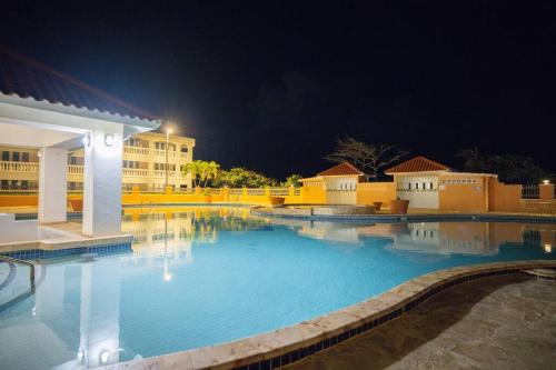 a large swimming pool at a hotel at night at Golden Dream Villas & Studio A/B Pool View in Isabela