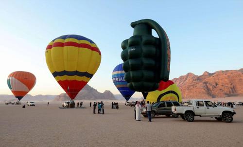a group of hot air balloons in the desert at Wadi Rum Faris in Wadi Rum