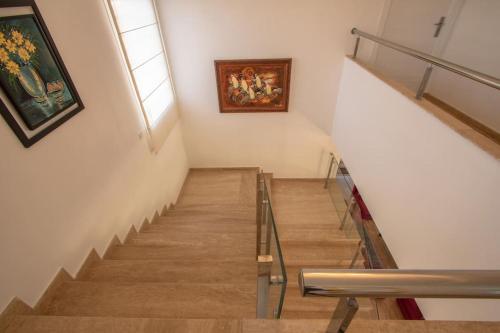 a staircase in a building with a painting on the wall at Villa Meriem, Fès in Oulad Tayeb