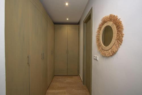 a hallway with a mirror and some closets at Villa Meriem, Fès in Oulad Tayeb
