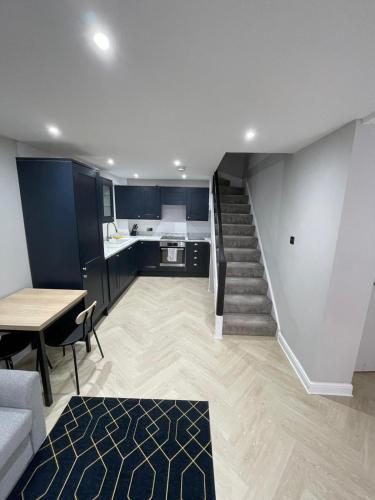 a living room with a staircase leading to a kitchen at Luxury modern 1 bedroom house in Southampton