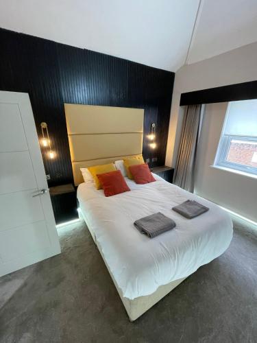 a bedroom with a large bed with two towels on it at Luxury modern 1 bedroom house in Southampton