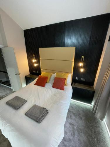 a bedroom with a large white bed with two towels on it at Luxury modern 1 bedroom house in Southampton