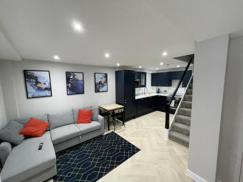 a living room with a couch and a table at Luxury modern 1 bedroom house in Southampton