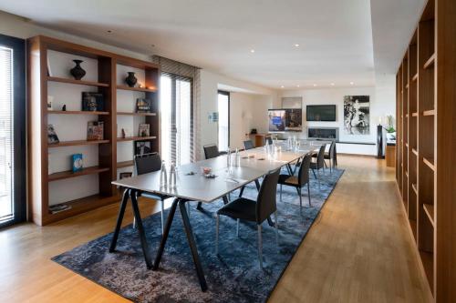 a dining room with a long table and chairs at Radisson Blu Hotel Milan in Milan