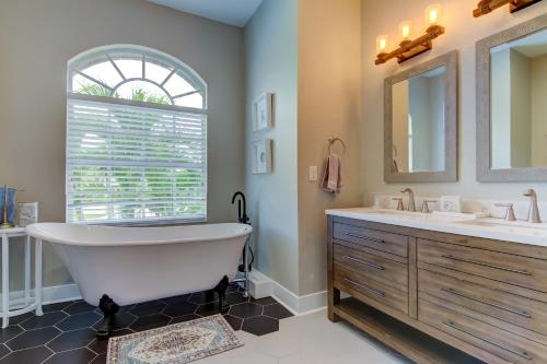 a bathroom with a tub and two sinks and a window at Coastal Haven in Apollo Beach