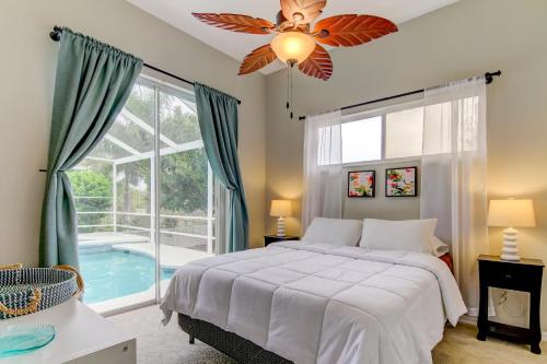 a bedroom with a bed and a window with a pool at Coastal Haven in Apollo Beach
