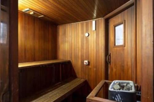 an empty sauna with a bench in a wooden room at One Bedroom Unit at Sydney Best Location in Sydney
