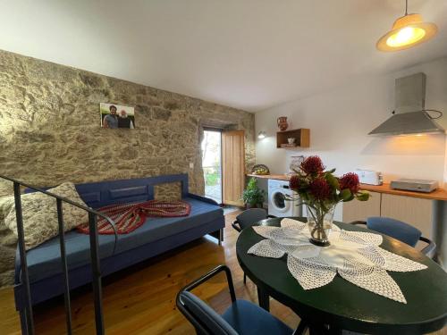 a living room with a table and a couch at AltaVista in Vitorino dos Piães