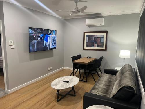a living room with a couch and a table at Northcott Lodge in Adamstown