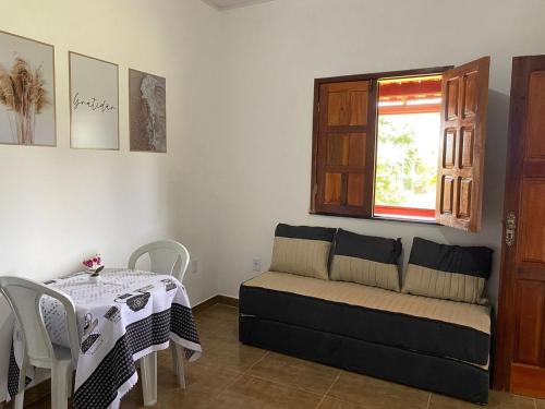 a living room with a couch and a table and a window at Pousada Alves e Almeida in Cayru