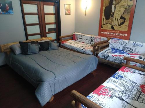 a bedroom with a bed and a couch at Hospedaje Casa Rojas in Bogotá