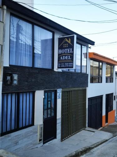 a building with a sign for the hotel ariel at Hotel Adel in Manizales