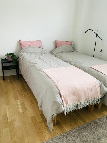 two beds sitting next to each other in a room at 2 Bedroom Rose Charm - by University in Kokkola