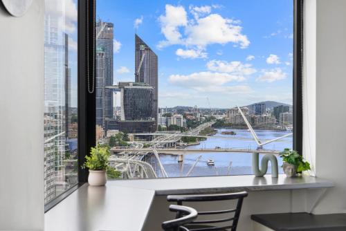 a kitchen with a view of the city from a window at 1-Bed Brisbane City Pad with Sweeping Views in Brisbane