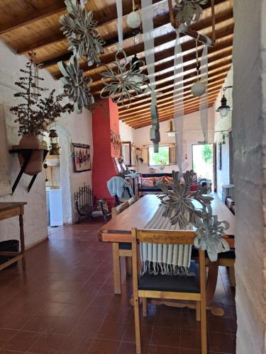 un comedor con una mesa de madera en una habitación en Aire de Barreal Hostel Andino en Barreal