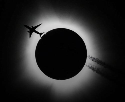 a plane flying in front of a solar eclipse at Casas de Ruumar Bed and Breakfast-Two rooms for family available in Clarin