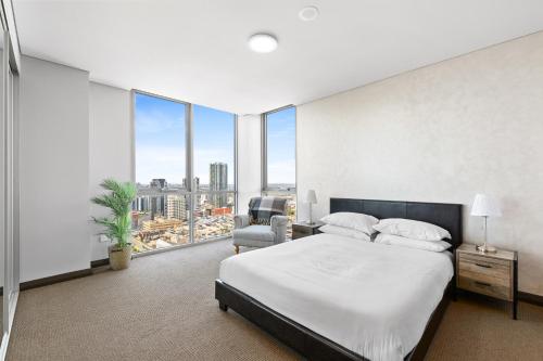 a bedroom with a bed and a large window at Central 2-Bed with Parking & Stunning Views in Sydney