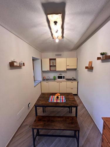 a kitchen with a table in the middle of a room at Giraluna in Demonte