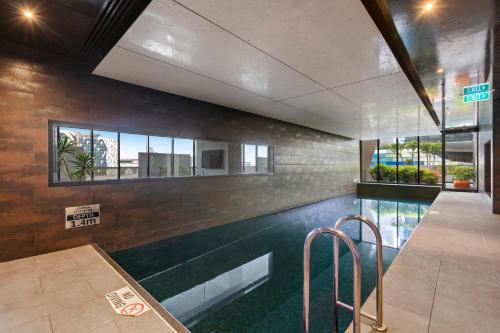 a swimming pool in the middle of a building at Complete Host NEO apartments in Melbourne