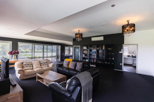 a living room with a couch and a table at Riverstone House in Camerons
