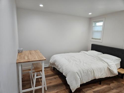 a white bedroom with a bed and a table at Sunset location 2Bed/1Bath Apt close to Golden Gate Park in San Francisco