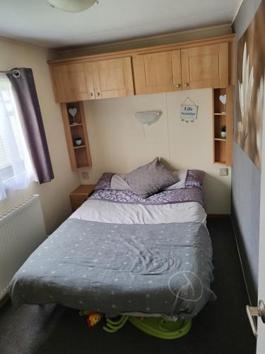 a small bedroom with a bed in the corner at Highfield grange clacton on sea in Little Clacton
