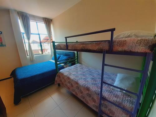 a bedroom with two bunk beds and a bed at Ayenda Mountain Hostels Manizales in Manizales