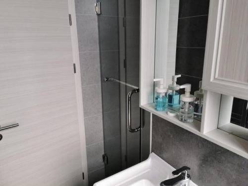 a bathroom with a shower with a sink and a toilet at Private Ensuite Studio with Kitchenette and Twin Beds in Sunderland