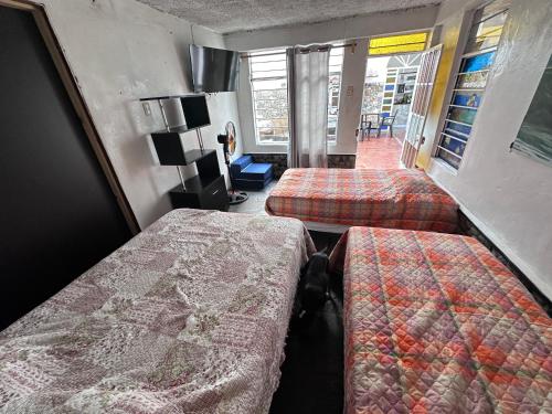 a room with two beds and a room with at La isla surf Camp de punta hermosa in Punta Hermosa