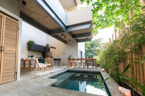 an indoor swimming pool in the backyard of a house at Alma Tropical - 4 Unit Luxury Villa Experience Santa Teresa in Santa Teresa Beach
