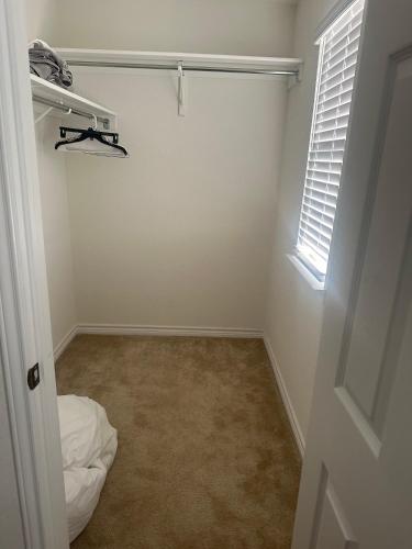 an empty room with a bed and a window at Spacious Room for Rent: Conveniently Located near Highway 1604! in San Antonio