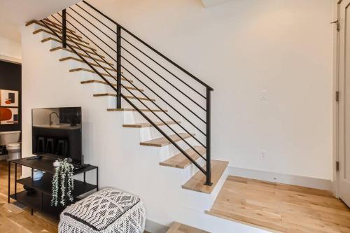 a spiral staircase in a living room with a chair at Upscale Townhome w/ Stunning Rooftop Views in Denver