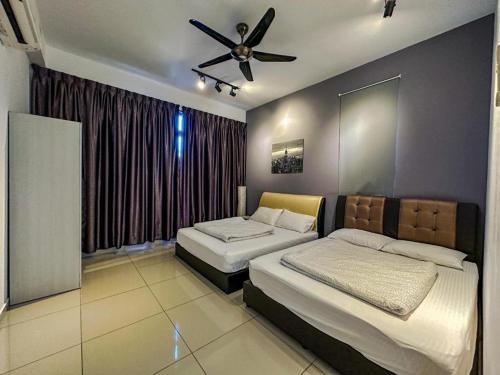 a bedroom with two beds and a ceiling fan at Atlantis Residence B19 5-6 pax l 5 mins Jonker St by Lullaby Retreats in Malacca